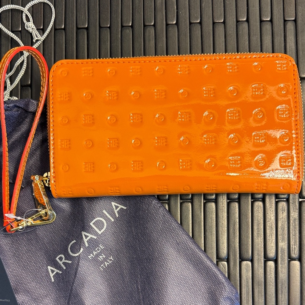 Arcadia zip around patent leather Wallet. “Tan” but looks more burnt orange.